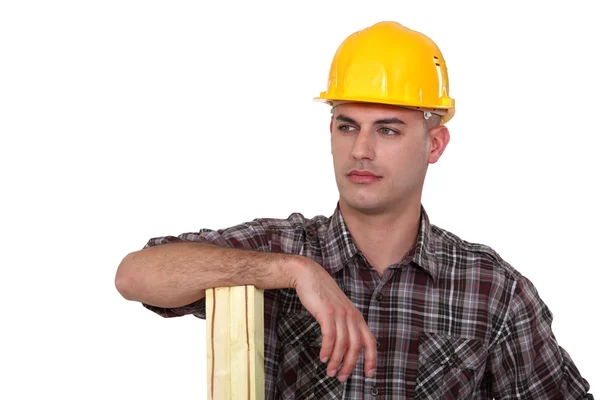 Builder stood with plank of wood — Stock Photo, Image