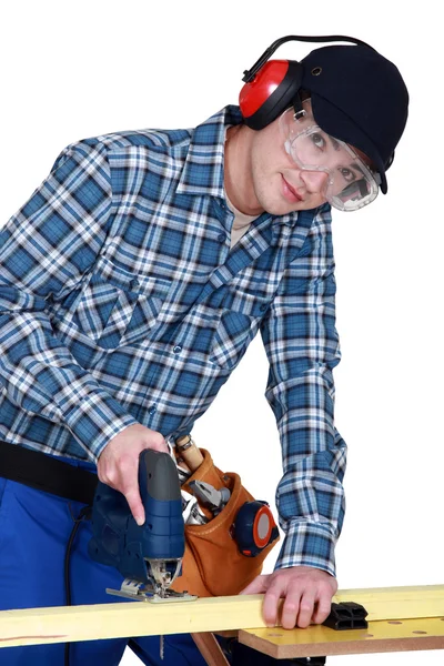 Carpenter boring a hole into a plank of wood — Stock Photo, Image
