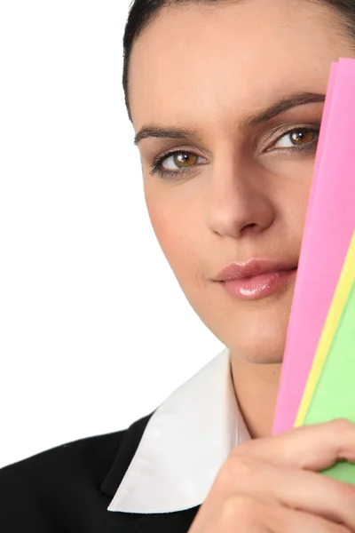 Woman's face behind folders — Stock Photo, Image