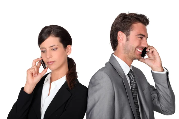 Businessman and woman with cellphones — Stock Photo, Image