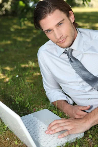 With computer on the grass — Stock Photo, Image
