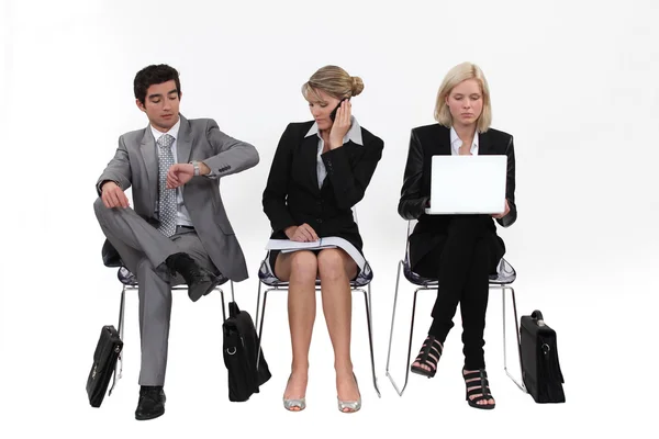 Business sitting in a row — Stock Photo, Image
