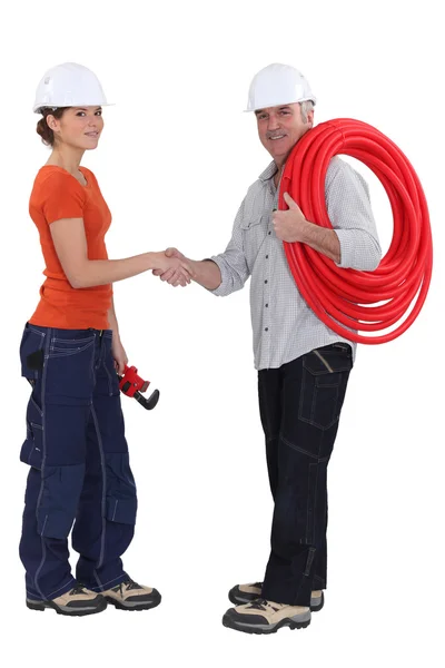Plumber with young female apprentice — Stock Photo, Image