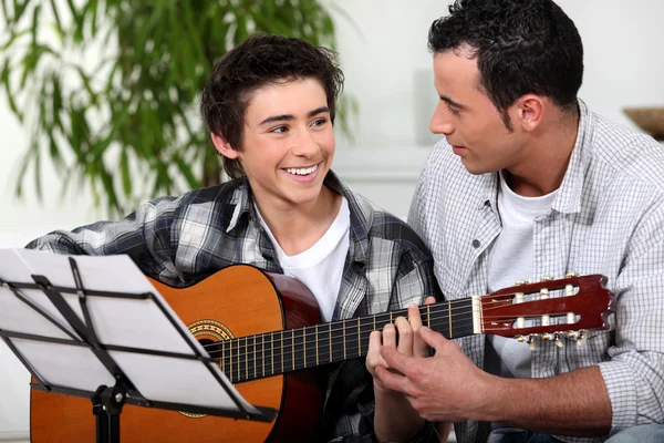 Father and son with acoustic guitar — Stock Photo, Image