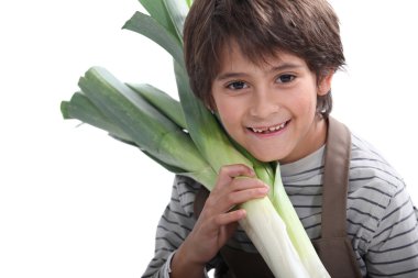 Portrait of a little boy holding leek clipart