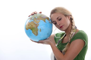 Woman in green resting her head against a large globe clipart