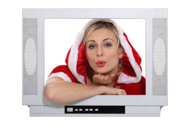 Woman dressed in festive outfit blowing kiss through television clipart