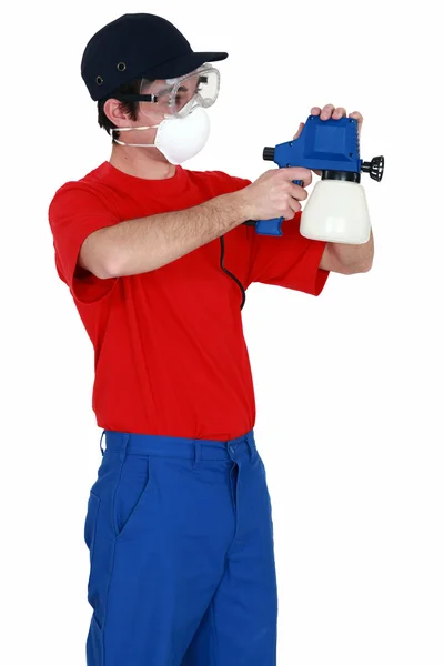 Man holding a paint sprayer — Stock Photo, Image