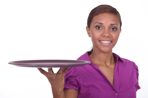 Attractive young waitress holding an empty tray — Stock Photo, Image