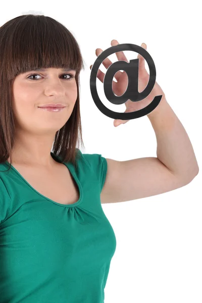 Girl holding an @ sign — Stock Photo, Image