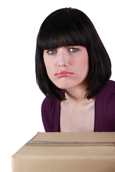 Sad brunette with box — Stock Photo, Image