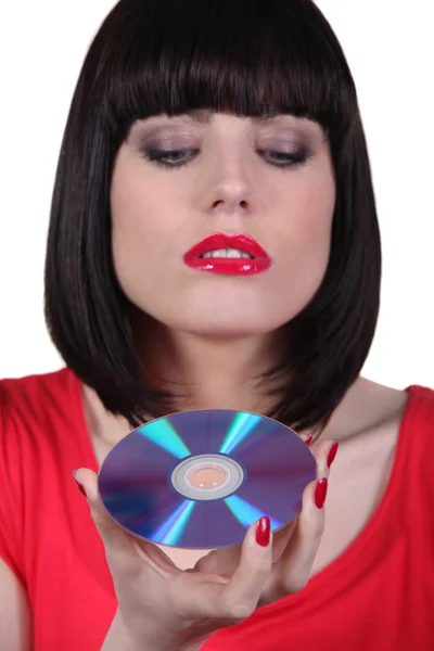 Brunette woman looking a cd — Stock Photo, Image