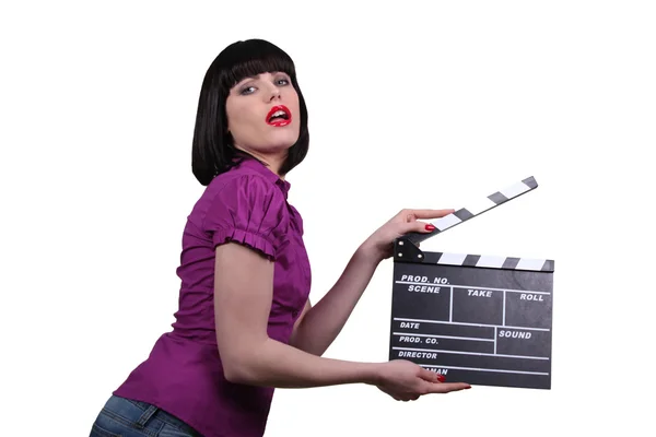 Woman holding up a clapperboard — Stock Photo, Image