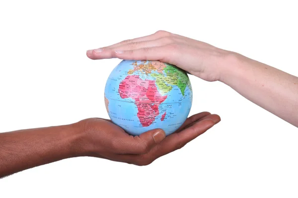 Two hands touching miniature globe — Stock Photo, Image