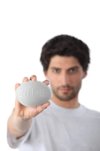 Man holding a bar of soap — Stock Photo, Image