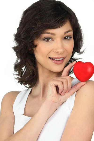 Brunette holding a red foam heart — Stock Photo, Image