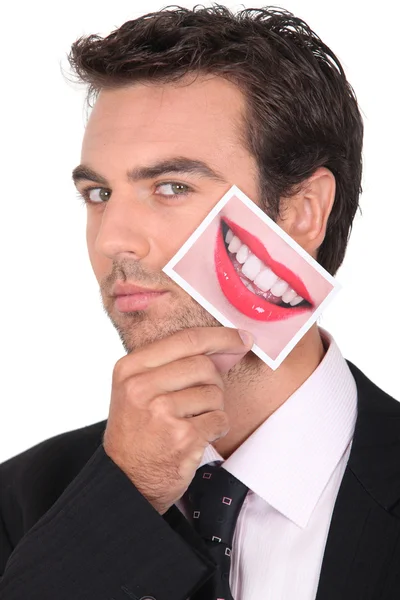 Uomo in giacca e cravatta con una foto di labbra — Foto Stock