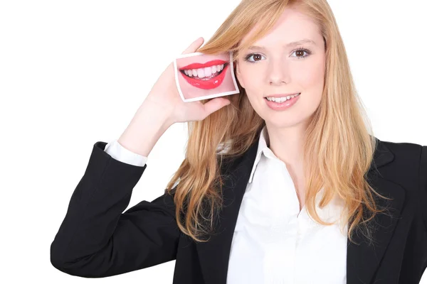 Cute blonde holding picture of smiling mouth — Stock Photo, Image