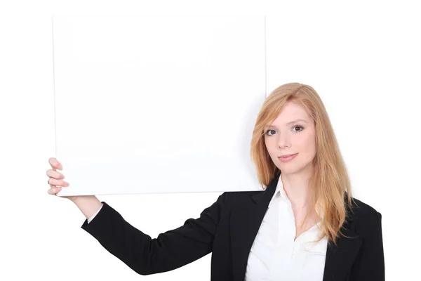 Businesswoman holding an advertising board — Stock Photo, Image