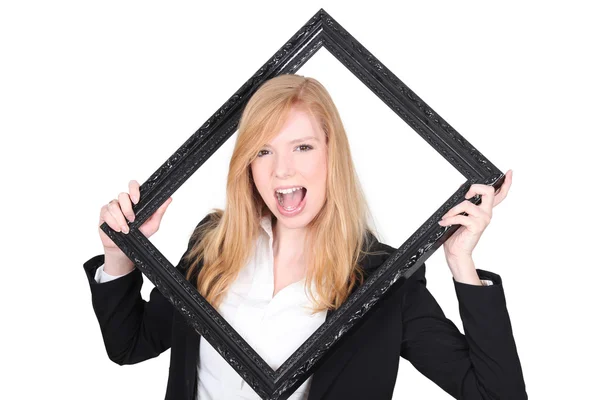 Young woman holding a black frame — Stock Photo, Image