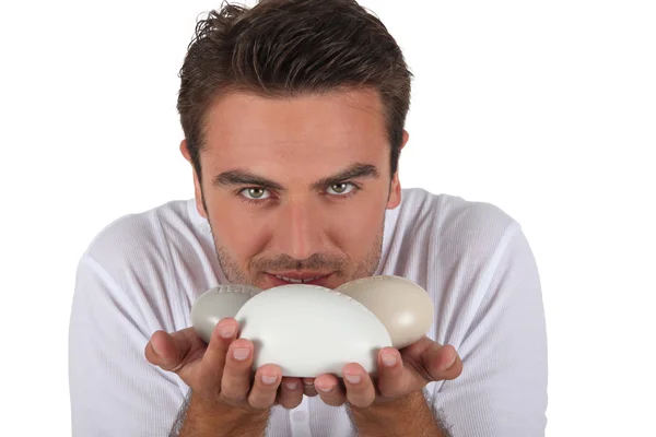 Man smelling bars of soap — Stock Photo, Image