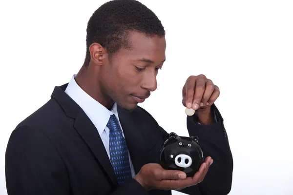 Muž s bankou piggy ve tvaru prasátka — Stock fotografie