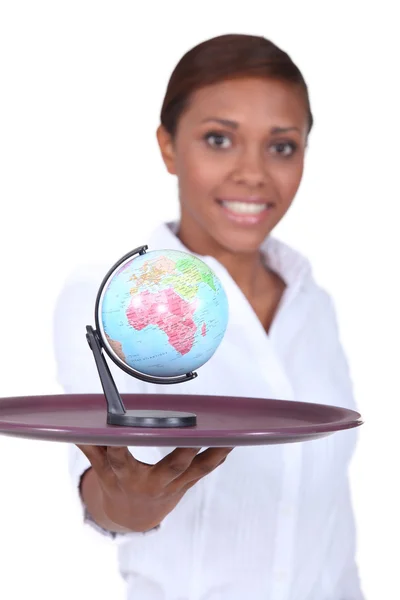 Woman holding tray with globe on it — Stock Photo, Image