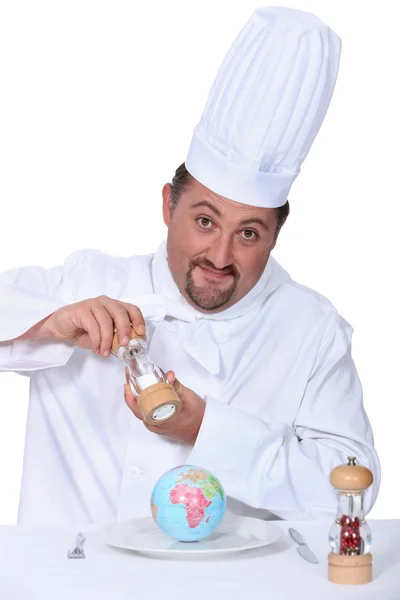 Koch würzt einen Globus — Stockfoto