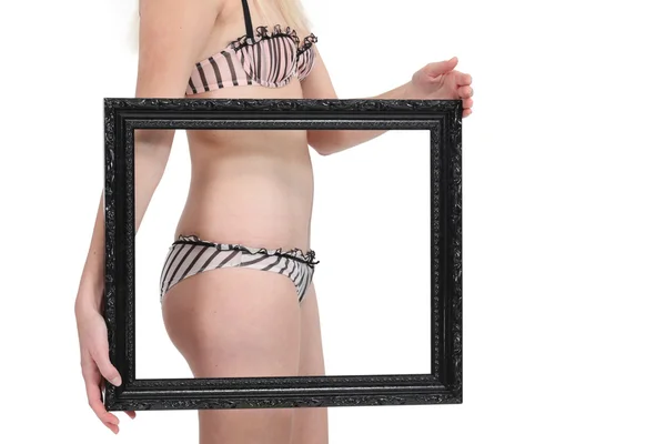 Lady in underwear holding black frame — Stock Photo, Image