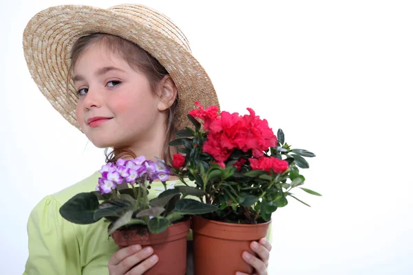 Little girl holding two flowerpots — Stock Photo, Image