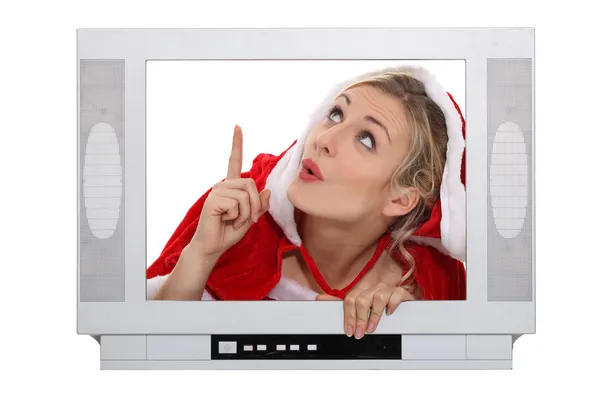 Vrouw gekleed in een santa pak binnen een televisie — Stockfoto