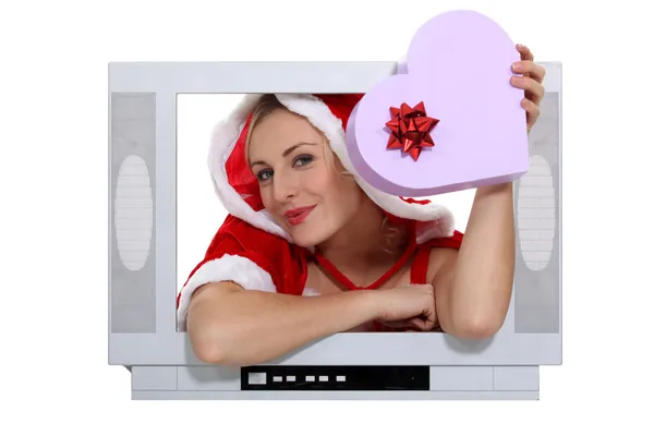 Woman jutting out of a television screen — Stock Photo, Image