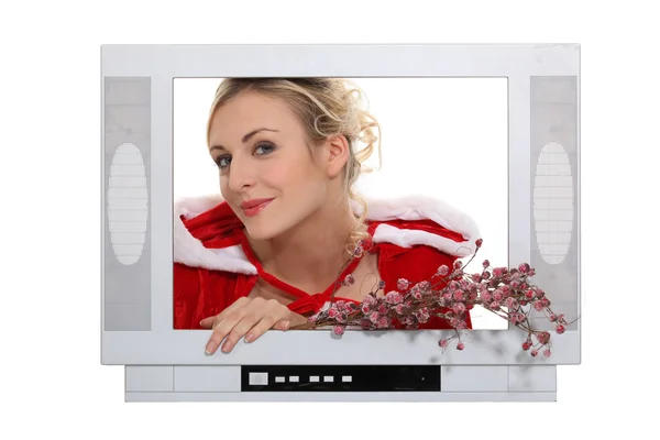 Woman dressed in festive outfit coming out of television — Stock Photo, Image