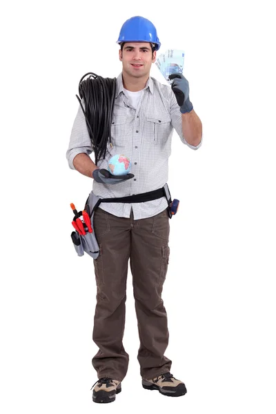 Craftsman holding money in cash and a globe — Stock Photo, Image