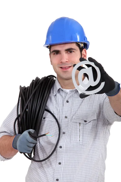 Cable guy holding an at sign — Stock Photo, Image