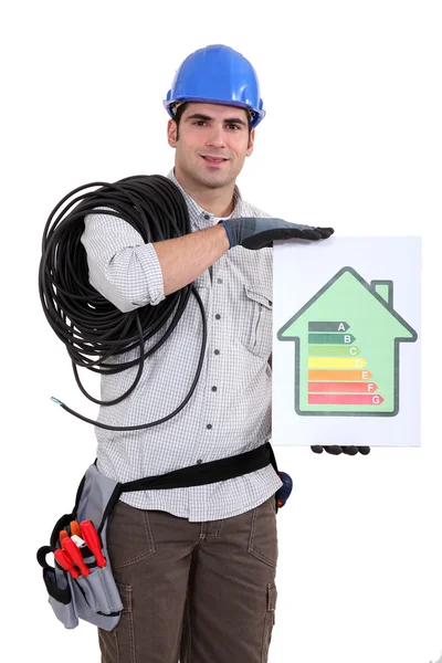 Tradesman holding an energy efficiency rating chart — Stock Photo, Image