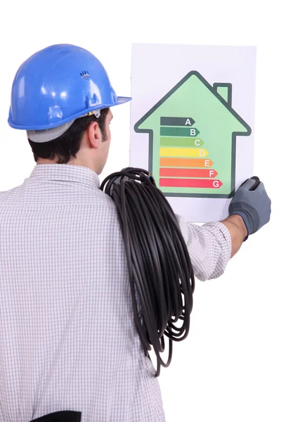 An electrician looking at a chart. — Stock Photo, Image
