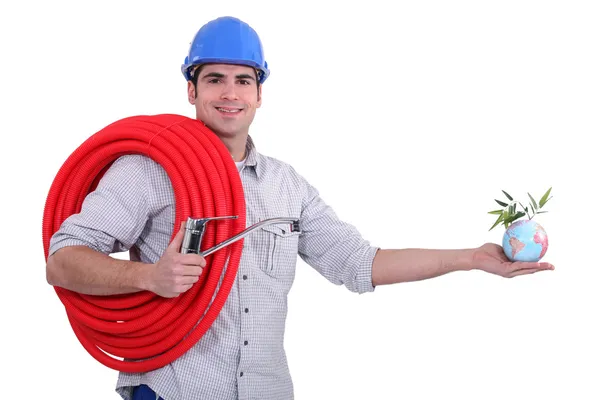Plumber holding coil and globe — Stock Photo, Image