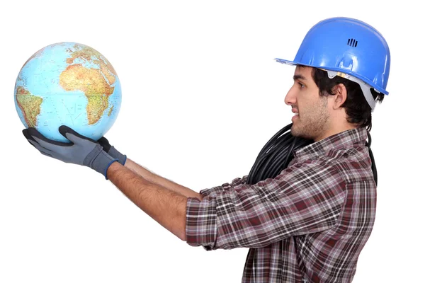 Laborer holding a globe — Stock Photo, Image