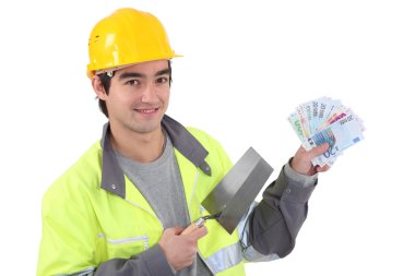 Tradesman holding a trowel and cash clipart
