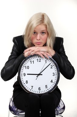 Woman leaning on wall clock clipart