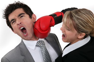 Woman punching her hard-headed colleague clipart