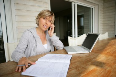 Women on the terrace with computer and phone clipart