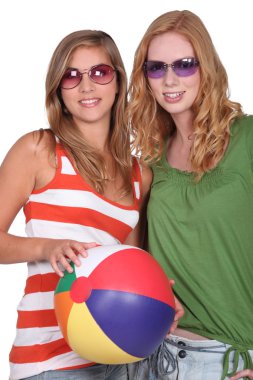 Studio shot of two girlfriends with a beachball clipart