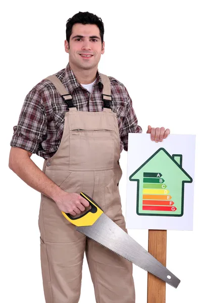 Builder holding up an energy efficiency rating sign — Stock Photo, Image