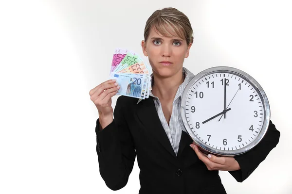 Woman with clock and notes in hand — Stock Photo, Image