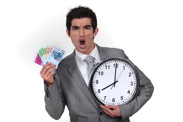 Homem de negócios animado com relógio e dinheiro — Fotografia de Stock