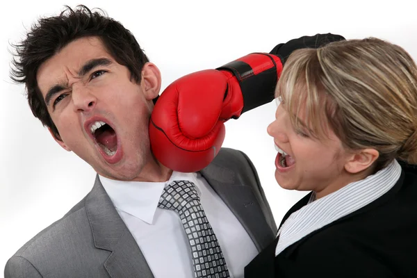 Woman punching her hard-headed colleague — Stock Photo, Image