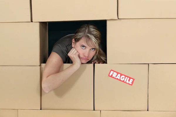 Woman surrounded by cardboard — Stock Photo, Image