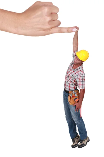 Montage of a tiny man hanging to a finger — Stock Photo, Image